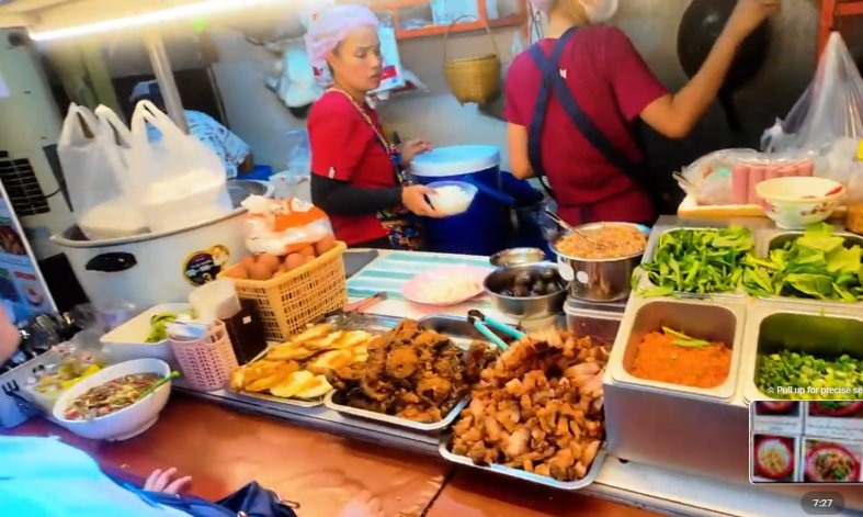 Bangkok street food sitting on trays ready to be served in a hidden alleyway near Siam BTS