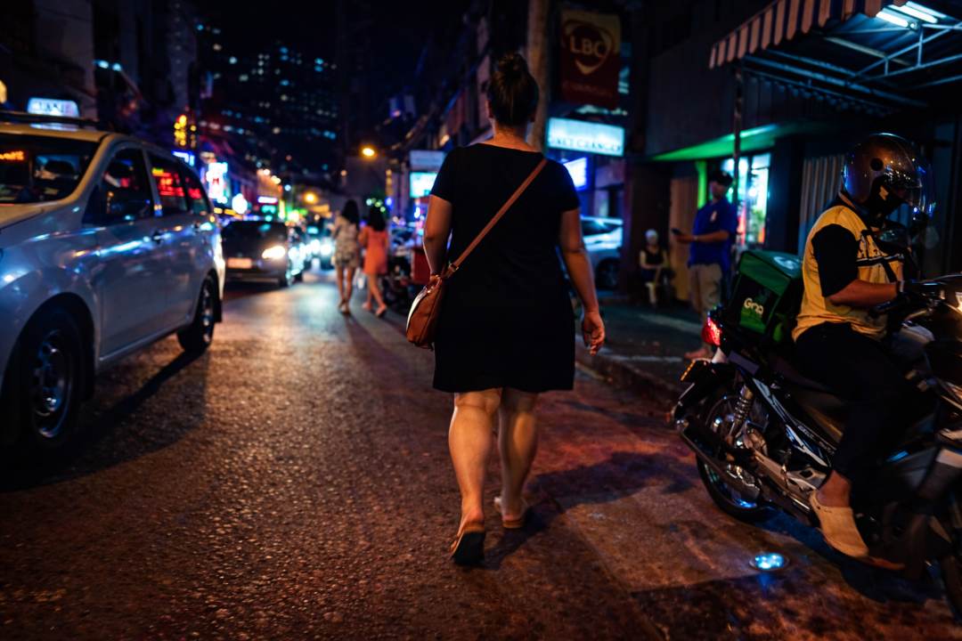 Bec from Street Eats and Window Seats walking along P Burgos Street in Makati Manila at night
