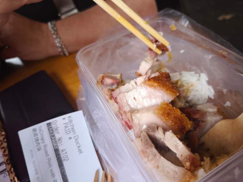 A takeaway container of crispy pork and rice from the Roast Bar in Glen Waverley Melbourne Australia