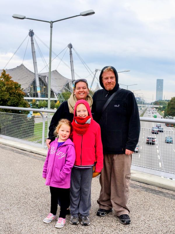 A family in Munich standing in front of Olympic Stadium