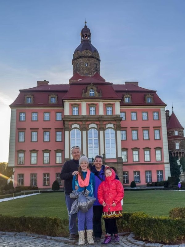 A family standing out front of Książ Castle in Wałbrzych, Poland