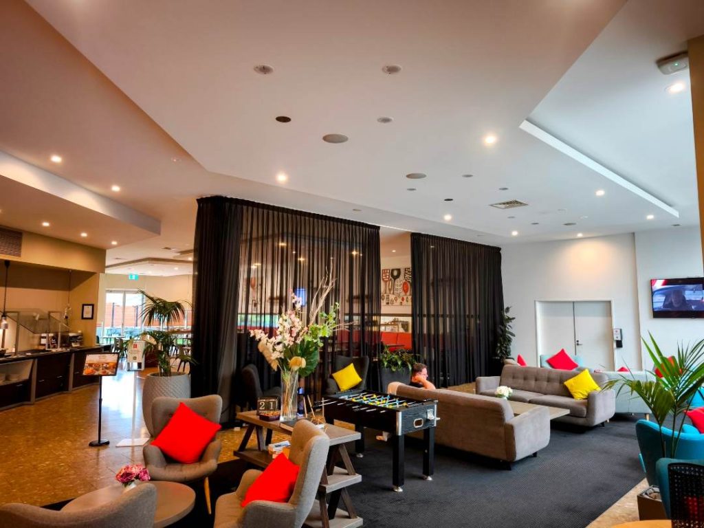 Ibis Glen Waverley lobby with foosball table, comfortable seating and bar area in Melbourne's eastern suburbs