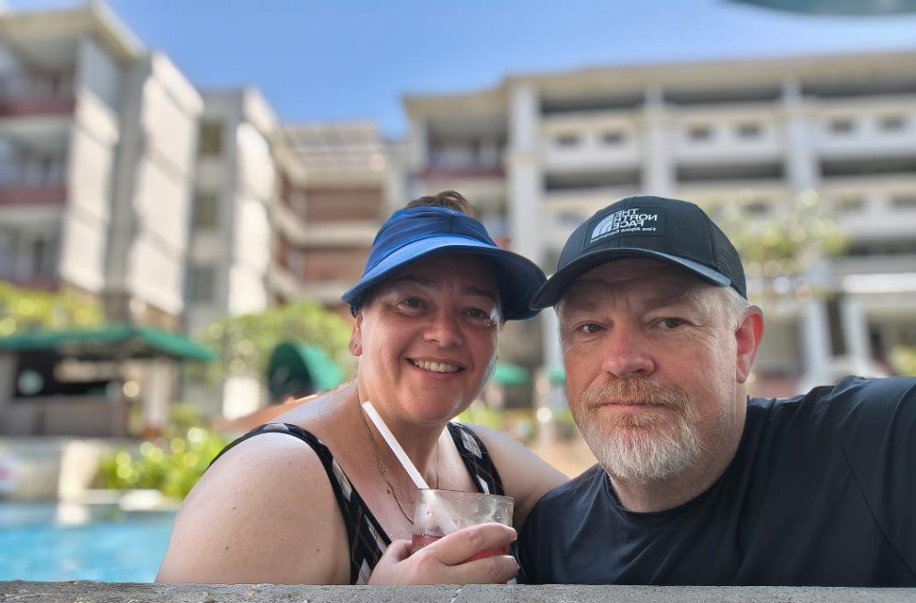Mark and Bec from Street Eats and Window Seats in a pool in Sanur Bali one of their top picks for slow long term travel in Asia