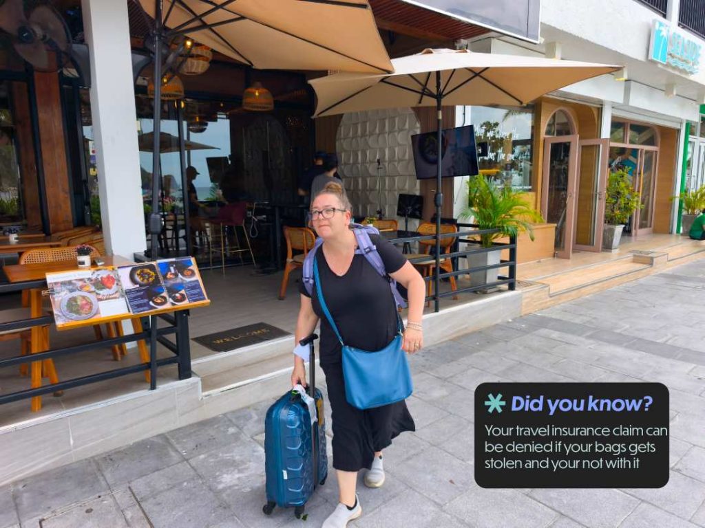 Bec pushing her suitcase to the ferry on Koh Phi Phi Thailand — always keep your luggage in sight