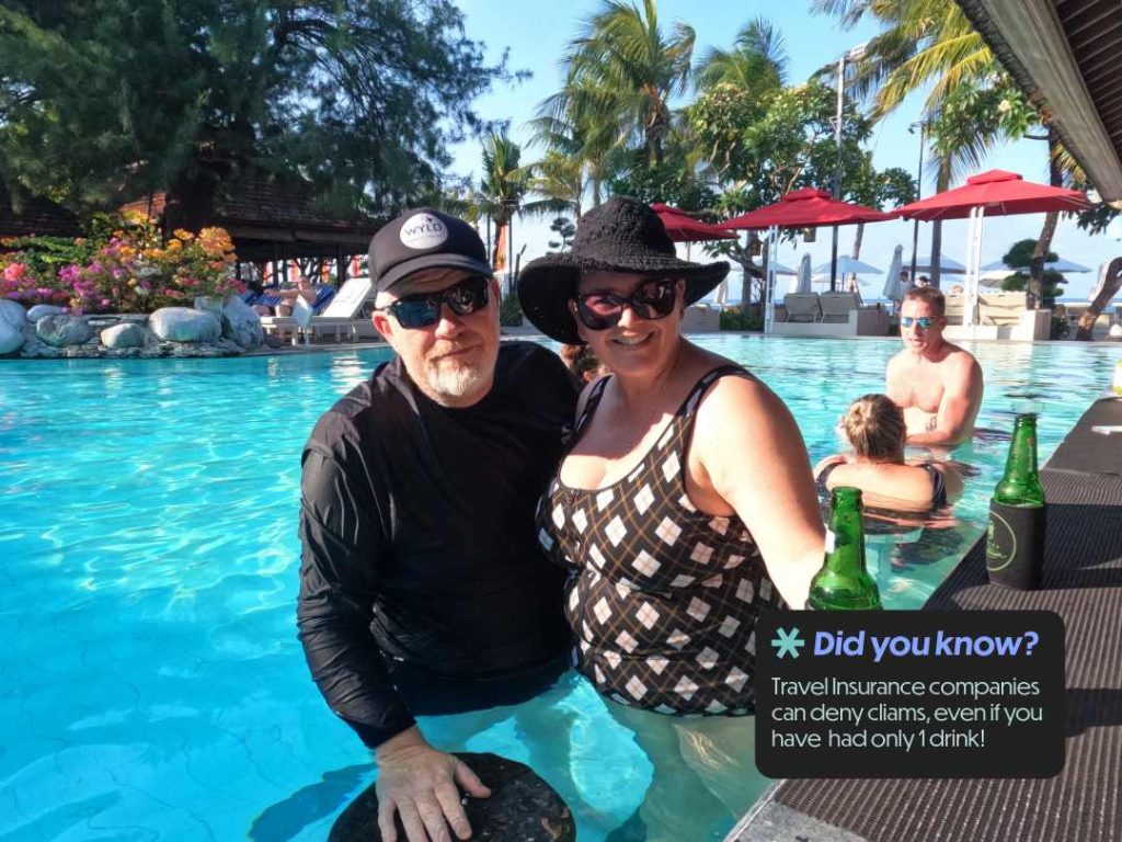 Mark and Bec having a cocktail at the pool bar in Sanur Bali — alcohol and travel insurance claims
